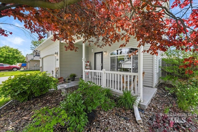 2175 W Willow Pointe Ave, Nampa, ID 83651 - view of property hidden behind natural elements featuring a porch and an attached garage