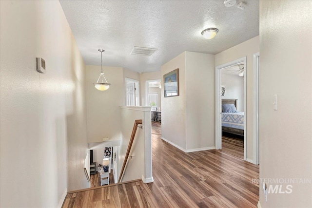 2175 W Willow Pointe Ave, Nampa, ID 83651 - hall featuring an upstairs landing, wood finished floors, a textured ceiling, and baseboards