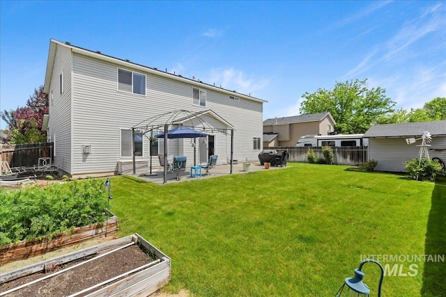 2175 W Willow Pointe Ave, Nampa, ID 83651 - back of house featuring a vegetable garden and a patio area