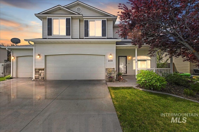 2175 W Willow Pointe Ave, Nampa, ID 83651 - traditional home featuring concrete driveway, a porch, an attached garage, and stone siding