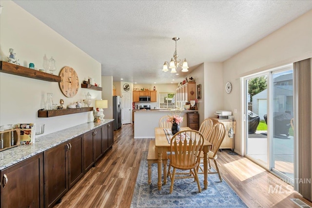2175 W Willow Pointe Ave, Nampa, ID 83651 - dining space with a textured ceiling, a chandelier, and light wood-type flooring