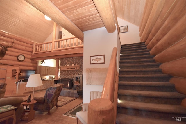 staircase featuring wooden ceiling, a stone fireplace, high vaulted ceiling, beamed ceiling, and hardwood / wood-style flooring