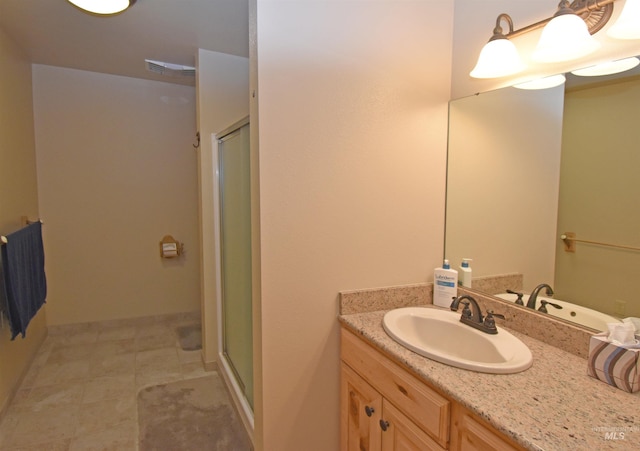 bathroom featuring vanity and a shower with door