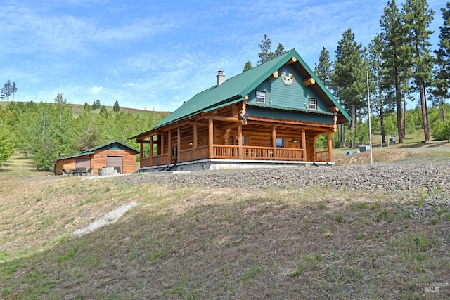 view of front facade with an outbuilding and a garage