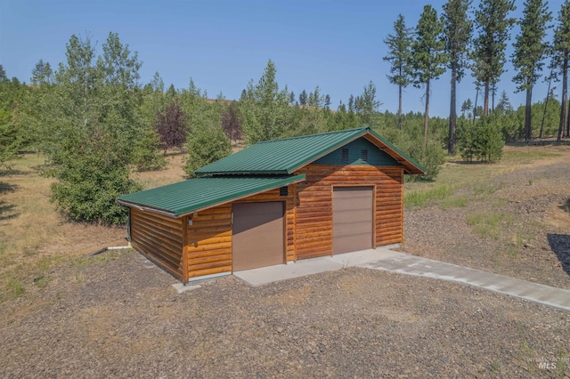 view of front of home featuring a garage and an outdoor structure