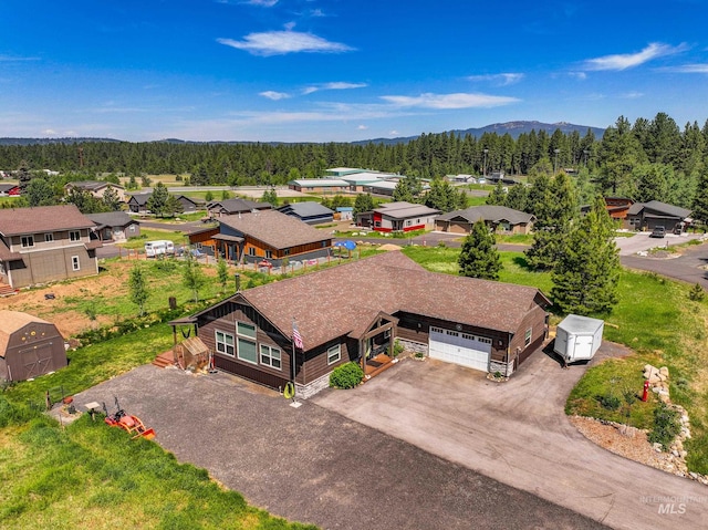 656 Fox Ridge Ln, Mccall, ID 83638 - aerial view of residential area featuring a heavily wooded area and a mountainous background