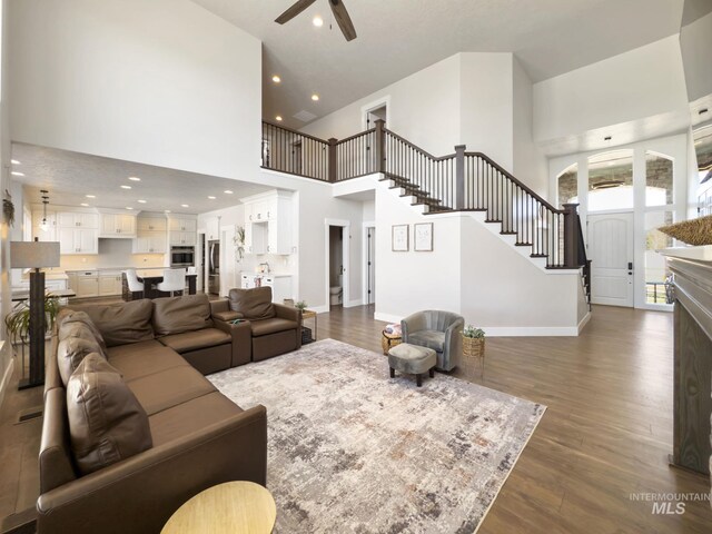 7063 S Pear Blossom, Meridian, ID 83642 - living area with ceiling fan, a high ceiling, stairway, dark wood-style floors, and recessed lighting
