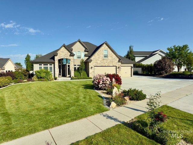 7063 S Pear Blossom, Meridian, ID 83642 - french country home with concrete driveway, stone siding, a garage, a front yard, and stucco siding