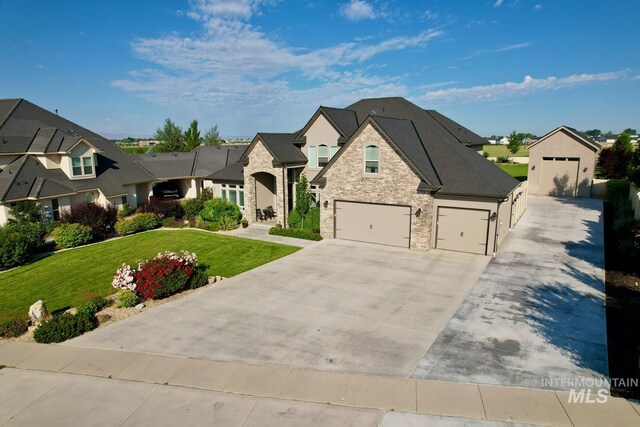 7063 S Pear Blossom, Meridian, ID 83642 - french country style house featuring stone siding, a residential view, a front lawn, and concrete driveway