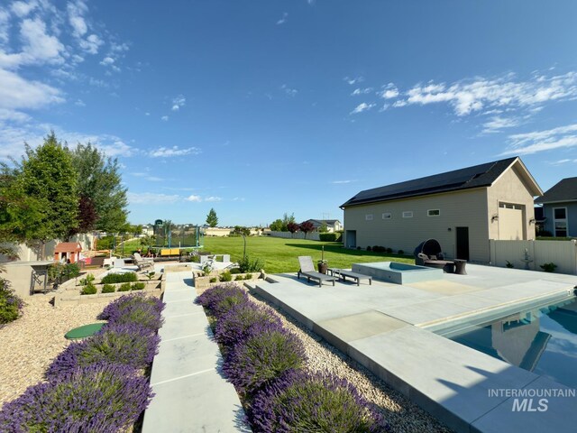 7063 S Pear Blossom, Meridian, ID 83642 - view of yard with a trampoline, a patio area, and a pool