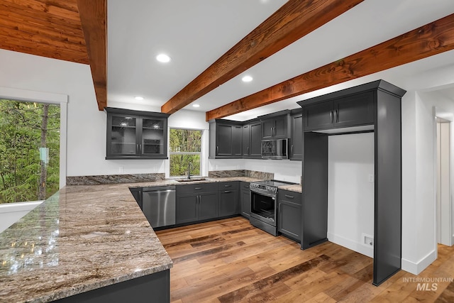 1 Caribou Pkwy, Cascade, ID 83611 - kitchen featuring appliances with stainless steel finishes, healthy amount of natural light, light stone countertops, a sink, and recessed lighting