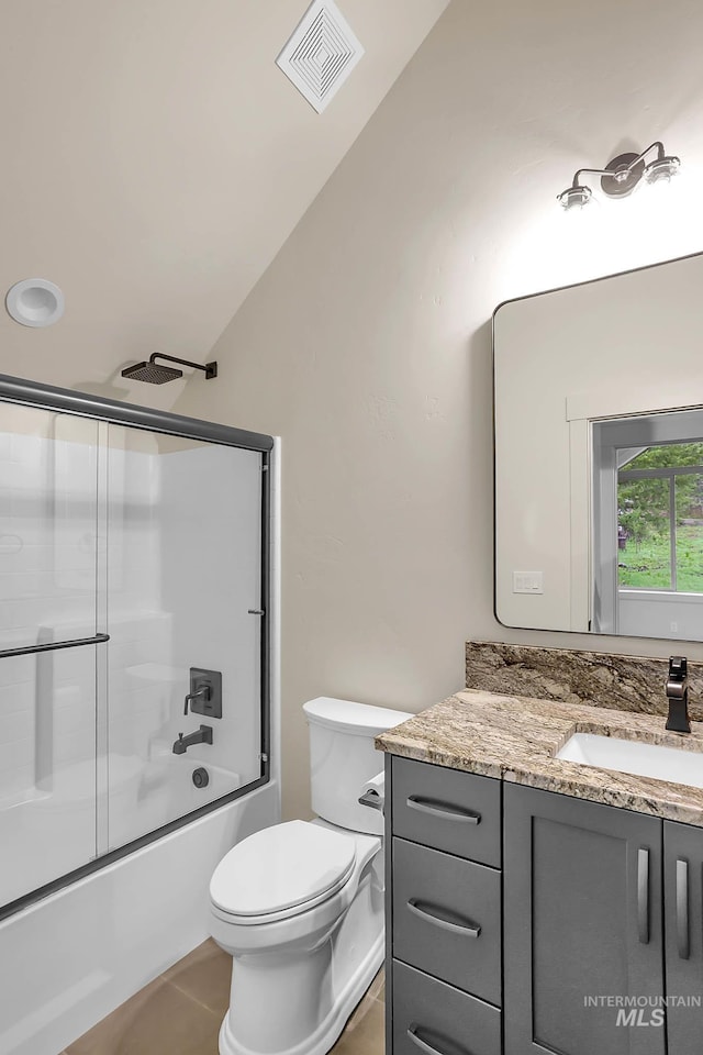 1 Caribou Pkwy, Cascade, ID 83611 - full bathroom with lofted ceiling, vanity, shower / bath combination with glass door, toilet, and tile patterned floors