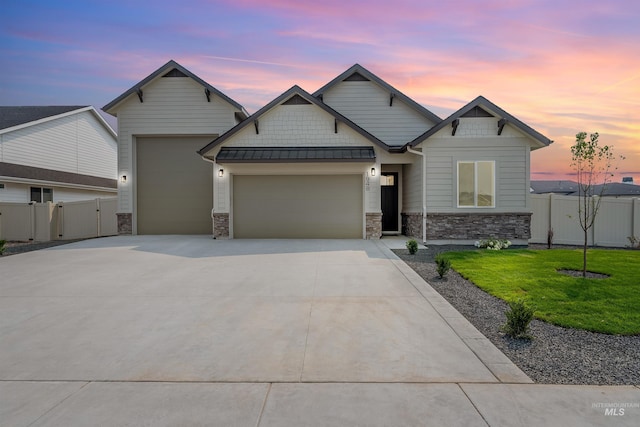 craftsman inspired home with a garage and a lawn