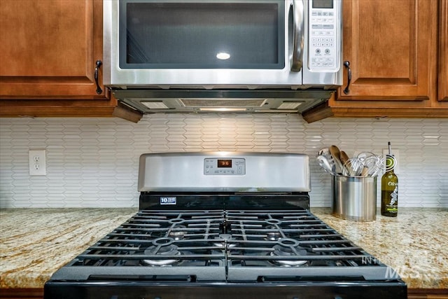1901 W Cherry Ct, Boise, ID 83705 - kitchen view of stainless steel appliances, tasteful backsplash, light stone counters, and brown cabinetry
