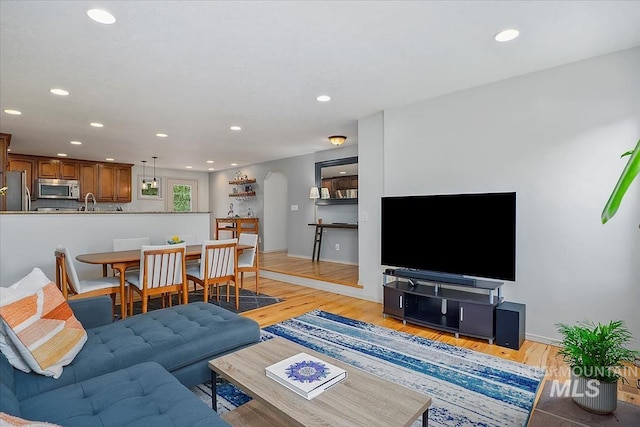 1901 W Cherry Ct, Boise, ID 83705 - living room featuring arched walkways, recessed lighting, and light wood-type flooring