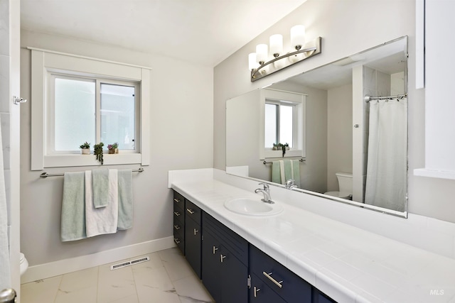 bathroom with vanity, visible vents, baseboards, toilet, and marble finish floor