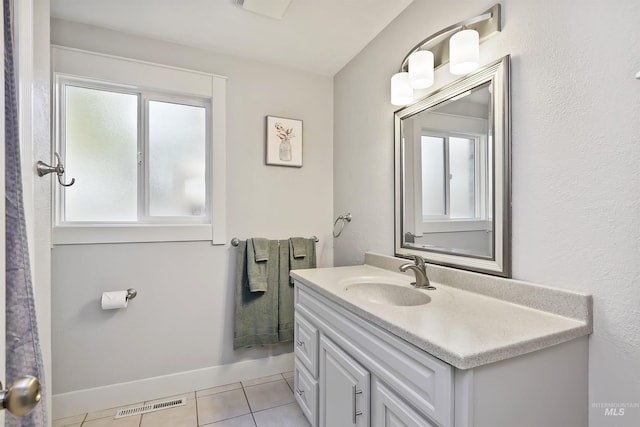 bathroom with tile patterned floors, visible vents, baseboards, and vanity