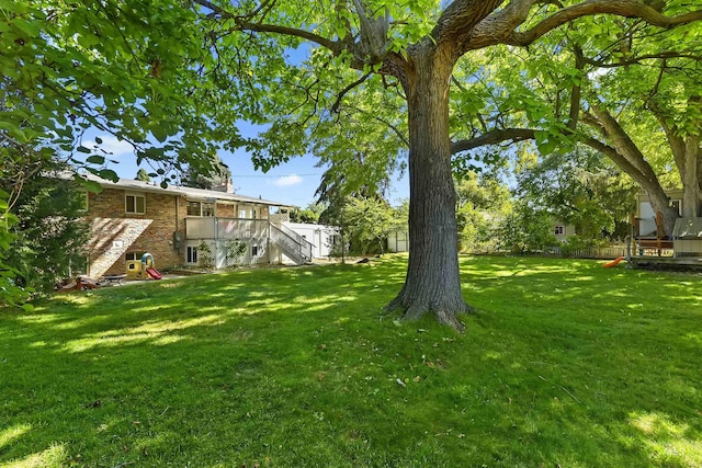 view of yard featuring stairs and a deck