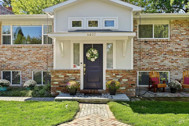 doorway to property with brick siding