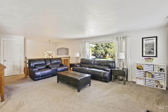 living room with a notable chandelier, baseboards, and carpet floors