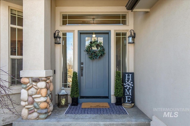 doorway to property with stucco siding