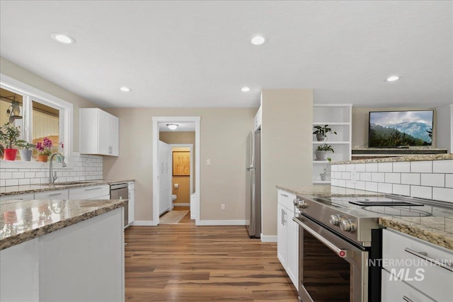 3600 S Robinson Blvd, Nampa, ID 83686 - kitchen with stainless steel appliances, backsplash, light wood finished floors, white cabinets, and light stone countertops