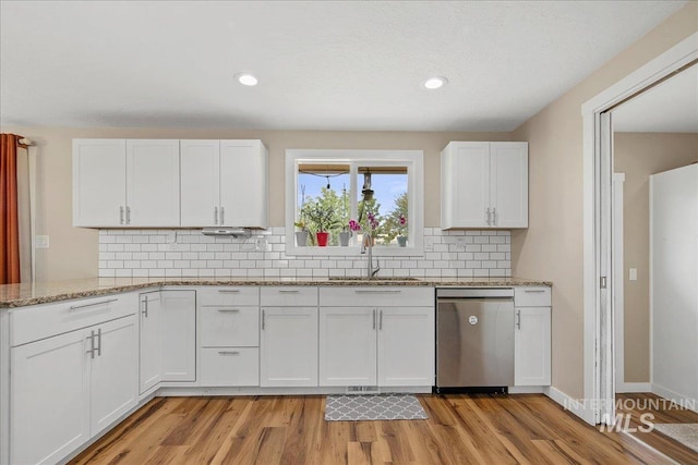 3600 S Robinson Blvd, Nampa, ID 83686 - kitchen with dishwasher, white cabinets, light wood finished floors, decorative backsplash, and light stone counters