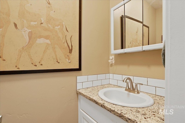 3600 S Robinson Blvd, Nampa, ID 83686 - bathroom featuring vanity and tasteful backsplash