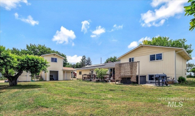 3600 S Robinson Blvd, Nampa, ID 83686 - rear view of house featuring solar panels, a yard, and a wooden deck