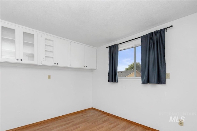 3600 S Robinson Blvd, Nampa, ID 83686 - unfurnished room with light wood-type flooring and a textured ceiling