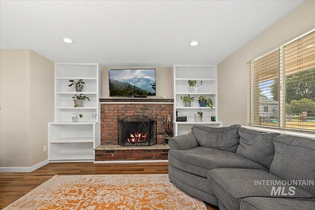 3600 S Robinson Blvd, Nampa, ID 83686 - living area with wood finished floors, a brick fireplace, and recessed lighting