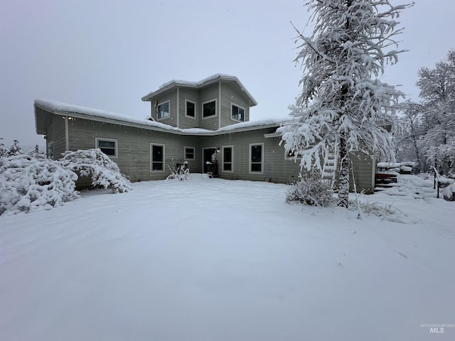 view of snow covered rear of property