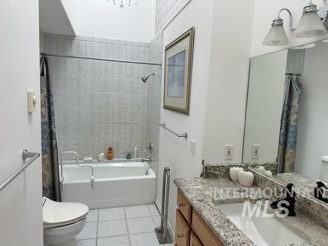 full bathroom featuring tile patterned floors, toilet, vanity, and shower / tub combo