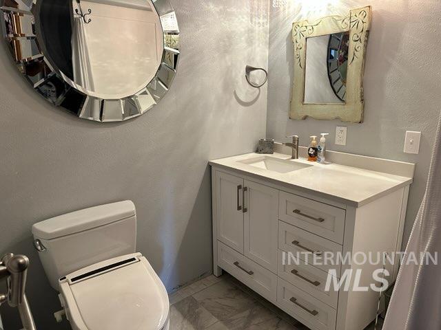 bathroom with vanity and toilet