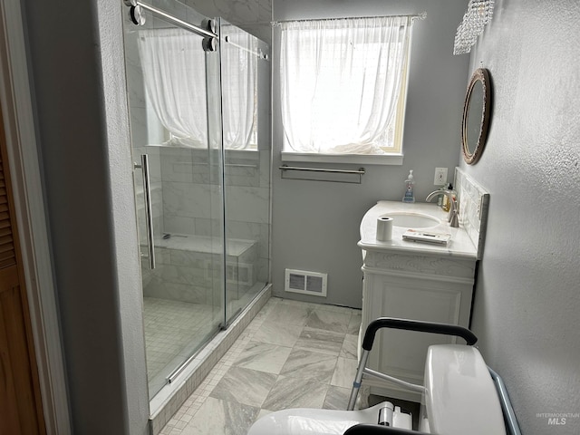 bathroom featuring vanity and an enclosed shower