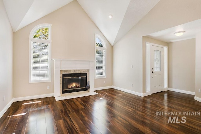 2500 W Orchard Ave, Nampa, ID 83651 - unfurnished living room with baseboards, a fireplace, vaulted ceiling, and hardwood / wood-style floors