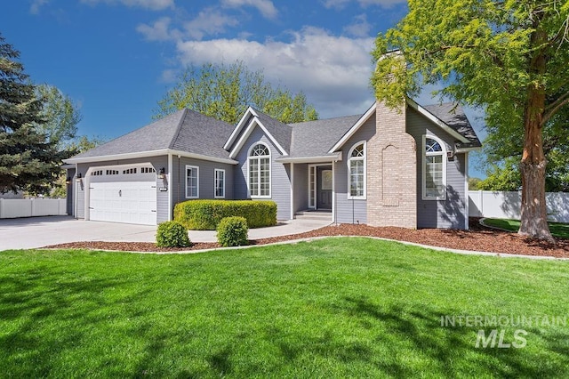 2500 W Orchard Ave, Nampa, ID 83651 - ranch-style house featuring a chimney, a garage, fence, a front lawn, and concrete driveway