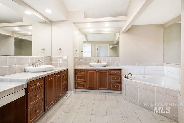 2500 W Orchard Ave, Nampa, ID 83651 - full bathroom with a sink, a bath, two vanities, and tasteful backsplash