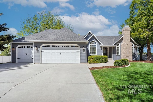 2500 W Orchard Ave, Nampa, ID 83651 - ranch-style house featuring roof with shingles, a garage, a front yard, a chimney, and driveway