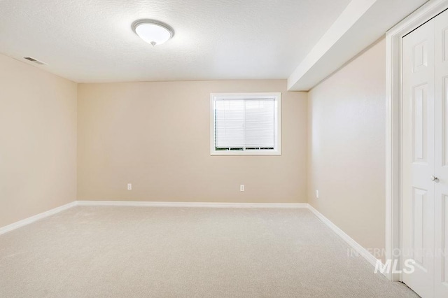 2500 W Orchard Ave, Nampa, ID 83651 - empty room with a textured ceiling, baseboards, and light carpet