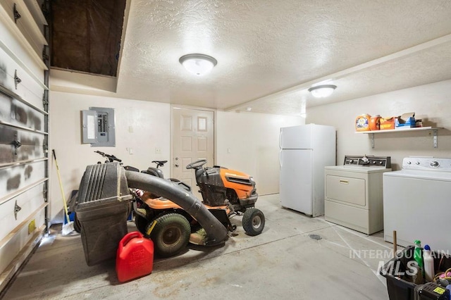 2500 W Orchard Ave, Nampa, ID 83651 - garage featuring electric panel, freestanding refrigerator, and washing machine and clothes dryer