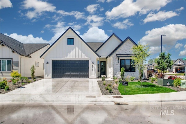 4603 S Hennessy Ave, Meridian, ID 83642 - modern farmhouse featuring board and batten siding, concrete driveway, stone siding, a front yard, and a garage