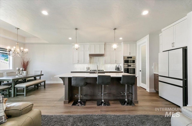 4603 S Hennessy Ave, Meridian, ID 83642 - kitchen featuring freestanding refrigerator, recessed lighting, double oven, a chandelier, and light countertops