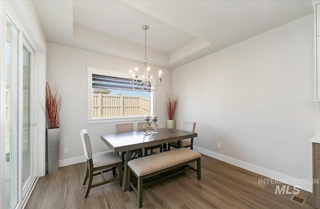 4603 S Hennessy Ave, Meridian, ID 83642 - dining space featuring wood finished floors, a chandelier, and a tray ceiling