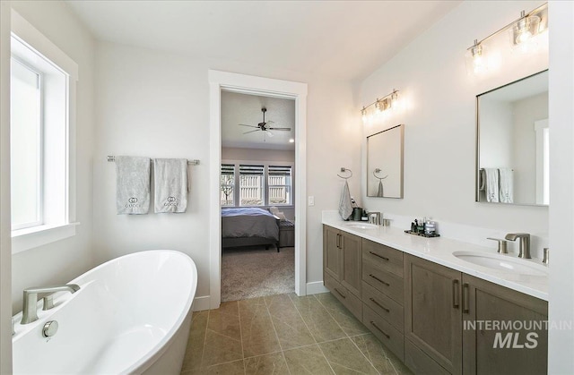 4603 S Hennessy Ave, Meridian, ID 83642 - ensuite bathroom with double vanity, a freestanding bath, a ceiling fan, and tile patterned flooring