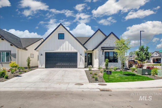 4603 S Hennessy Ave, Meridian, ID 83642 - modern inspired farmhouse featuring board and batten siding, driveway, stone siding, and a front yard