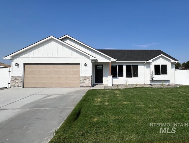 view of front of house with a garage and a front lawn