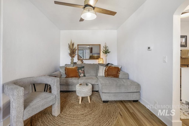 1138 Normal Ave, Burley, ID 83318 - living room with arched walkways, wood finished floors, ceiling fan, and baseboards