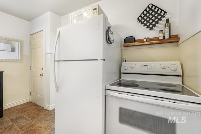 1138 Normal Ave, Burley, ID 83318 - kitchen with white appliances, baseboards, and stone finish floors