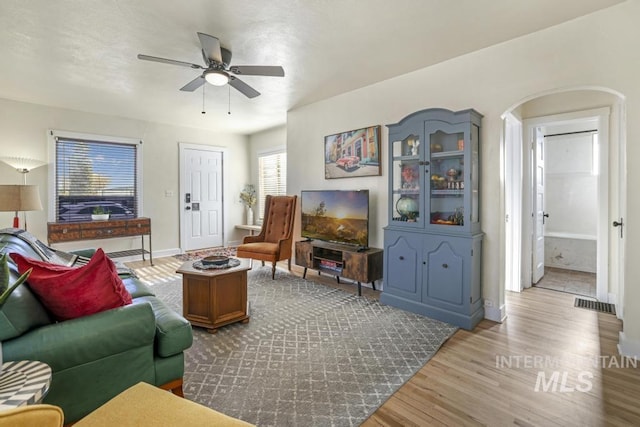 1138 Normal Ave, Burley, ID 83318 - living area featuring a ceiling fan, wood finished floors, baseboards, and arched walkways